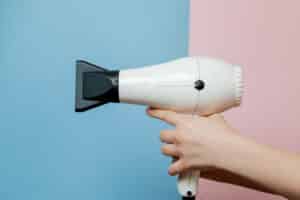 Hands with hair dryer